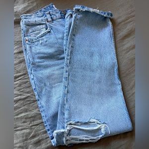 Vintage style light wash jeans with holes